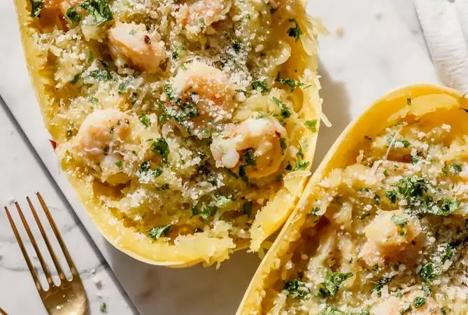 shrimp scampi spaghetti squash stuffed inside spaghetti squash boats with 2 forks