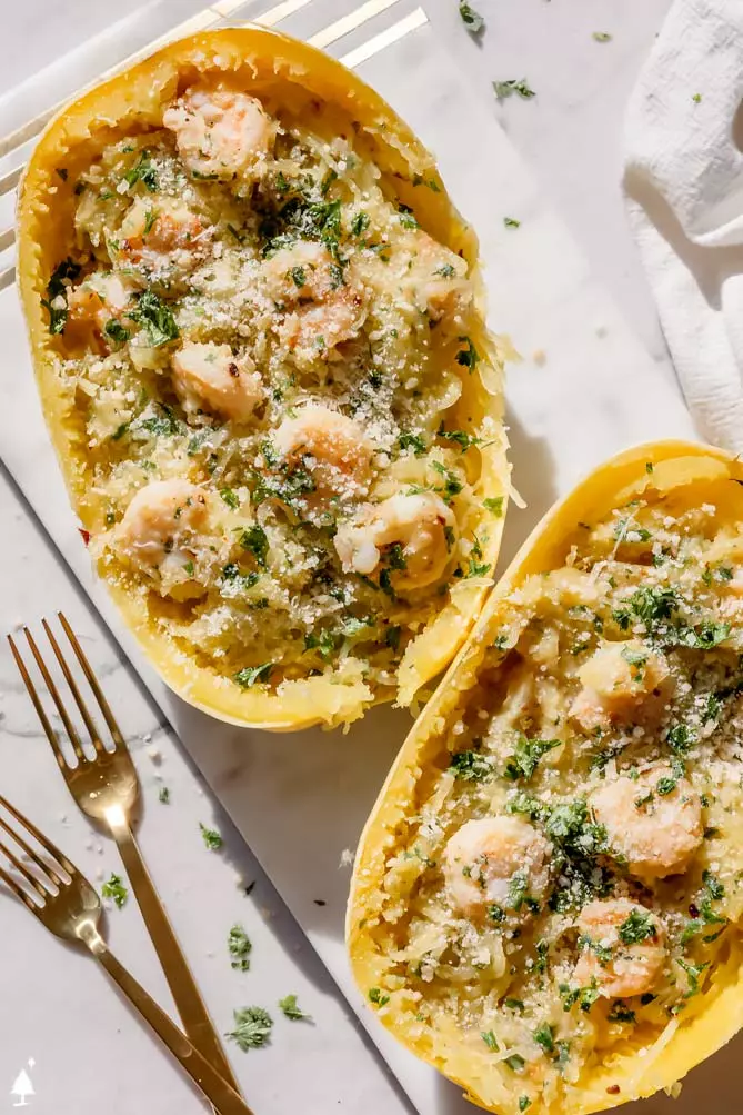 shrimp and spaghetti squash stuffed inside spaghetti squash boats with 2 forks