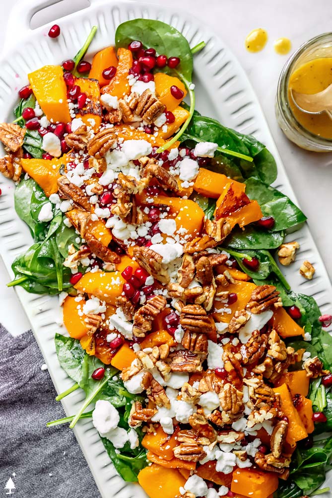 roaasted squash salad with feta, pomegranate seeds, and greens