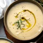 cream of cauliflower soup in a bowl with an olive oil drizzle