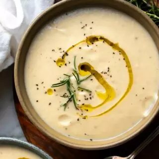 cream of cauliflower soup in a bowl with an olive oil drizzle
