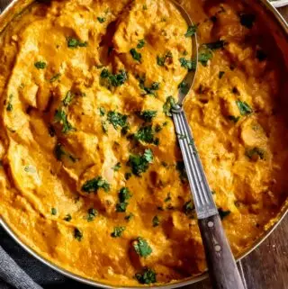 chicken korma recipe in a pan with a spoon