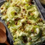 fennel salad recipe on a platter with apple slices and pecans