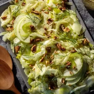 fennel salad recipe on a platter with apple slices and pecans