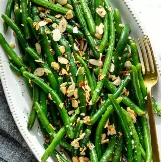 green beans almondine recipe on a platter with a fork