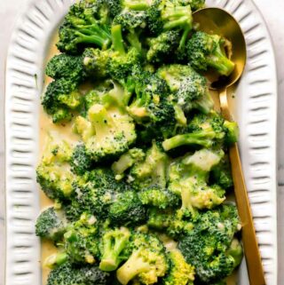 broccoli and cheese recipe on a platter with a spoon