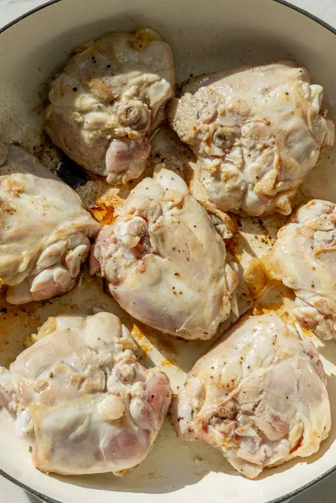 chicken provencal recipe being seared in a large skin