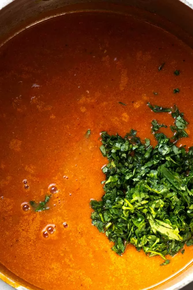 adding cilantro to chicken tikka masala soup