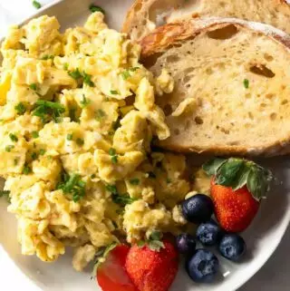 cottage cheese eggs on a plate with chives and buttered toast