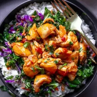 harissa honey chicken in a bowl over. rice and salad