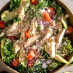 kale chicken salad in a bowl with tomatoes and pepitas