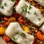 Mediterranean Sea Bass recipe on a baking pan with tomatoes
