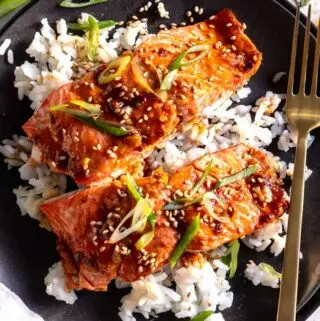 sweet spicy salmon recipe on a plate over rice