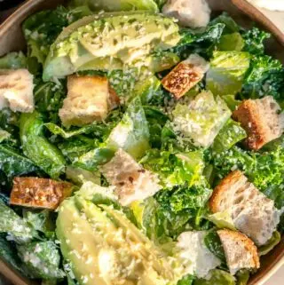 kale salad ideas in a bowl with additional dressing on the side