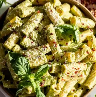 broccoli pesto recipe tossed in pasta with basil on top