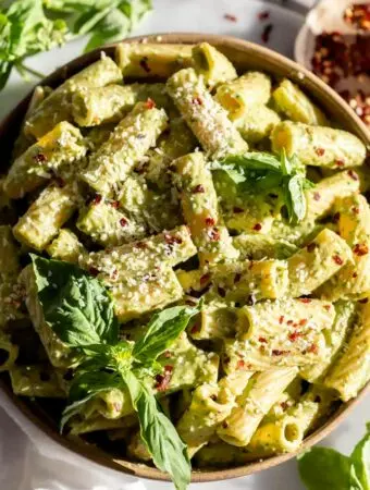 broccoli pesto recipe tossed in pasta with basil on top