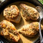 dill chicken recipe in a skillet with a spoon and wine