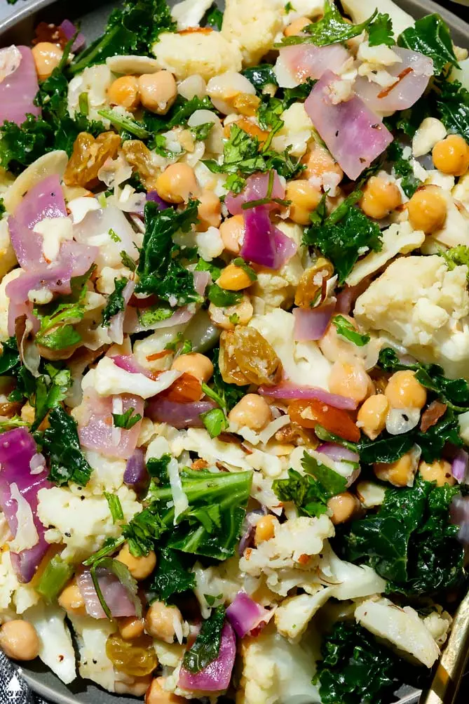 cold cauliflower salad on a plate with kale and chickpeas