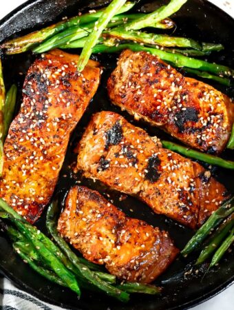 honey glazed salmon recipe in a pan with green beans
